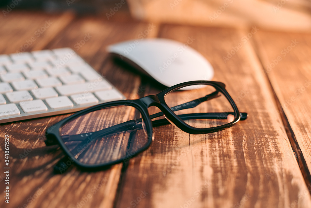 Glasses for sight and vision correction and protection from computer on the wooden table Glasses for sight and vision correction and protection from computer on the wooden table