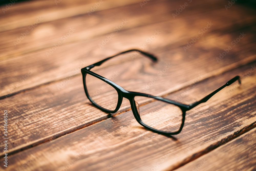 Glasses for sight and vision correction and protection from computer on the wooden table Glasses for sight and vision correction and protection from computer on the wooden table
