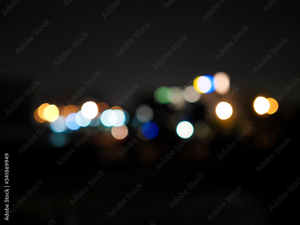 Blurred and soft focus of colorful circle bokeh lights on black background.