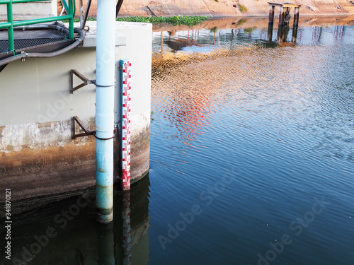 water surface in water treatment pond and drought water level gauge line in canal.