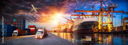 Container truck in ship port for business Logistics and transportation of Container Cargo ship and Cargo plane with working crane bridge in shipyard at sunrise, logistic import export and transport 