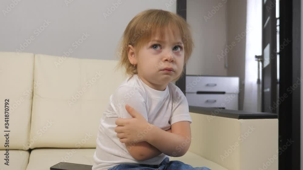 little a girl offended hugs herself with lifestyle her hands. blonde girl indoors angry little a girl offended hugs herself with lifestyle her hands. blonde girl indoors angry