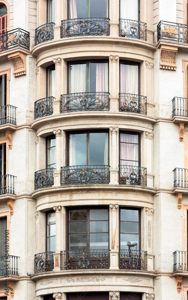 Round balconies with ionic pilasters and wrought iron grilles