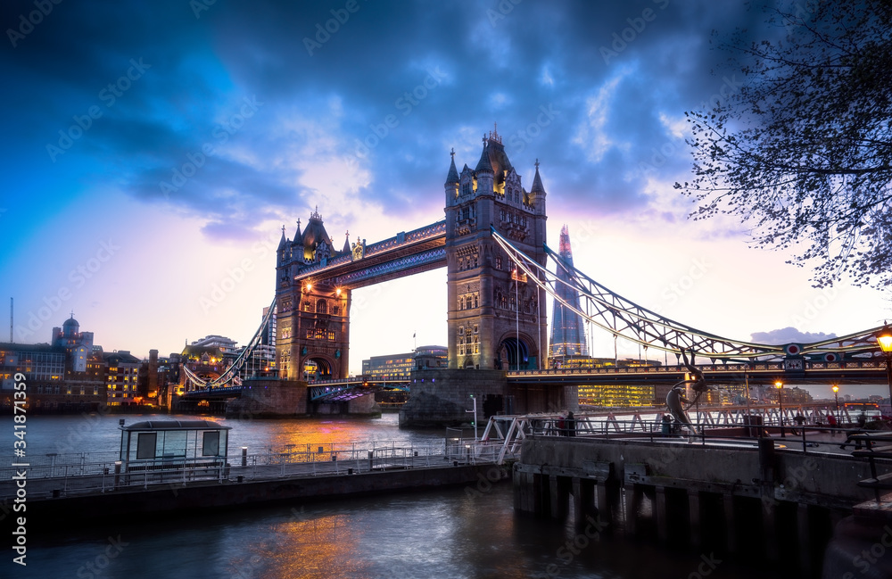 Obraz premium Famous Tower Bridge over themes river London at night London, Aerial view to the illuminated Tower Bridge and skyline of London