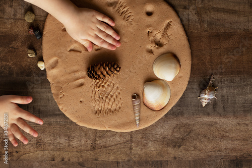 Modeling with salt dough on the kitchen table. Natural materials for the game, the natural composition of the product. Creative development of children in the period of self-isolation
