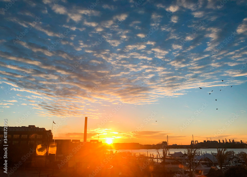 Sunrise over city - beautiful rainbow of colors - blue, red, orange, yellow - perfect new day or new beginning