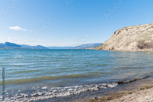 Scenic view of Okanagan Lake  sandstone cliffs  blue sky and mountains