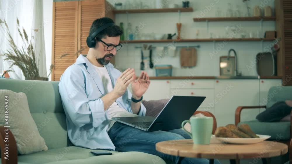 Person works from home with a laptop during coronavirus pandemic. Person works from home with a laptop during coronavirus pandemic.