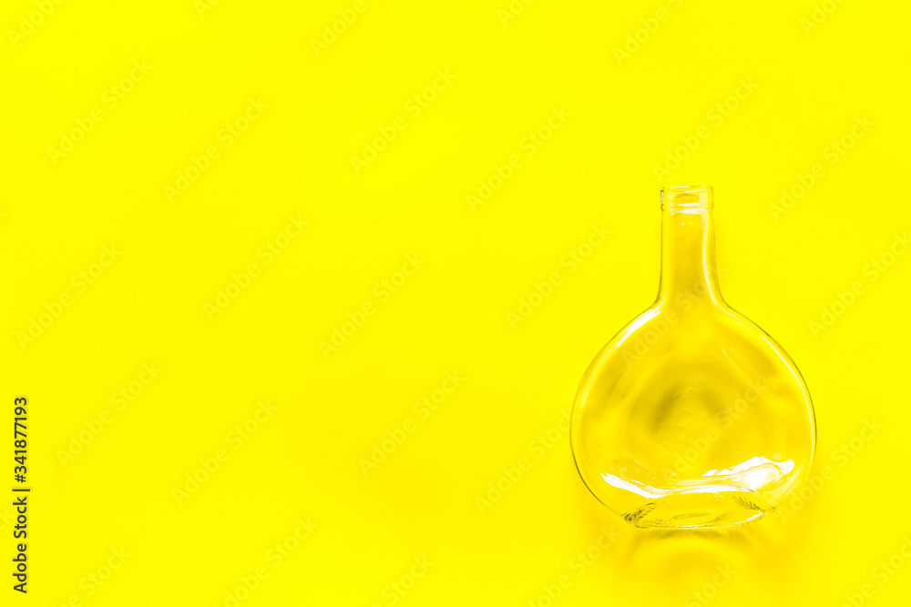 Bottle for recycling on yellow background top view copy space