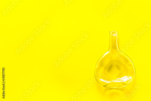Bottle for recycling on yellow background top view copy space
