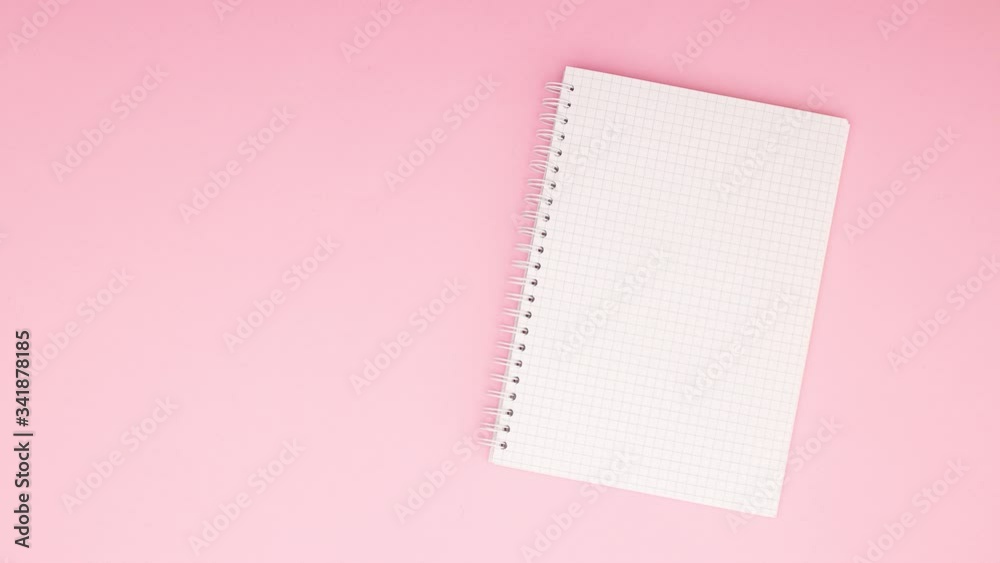 Opened notebook moving on pink background - Stop motion