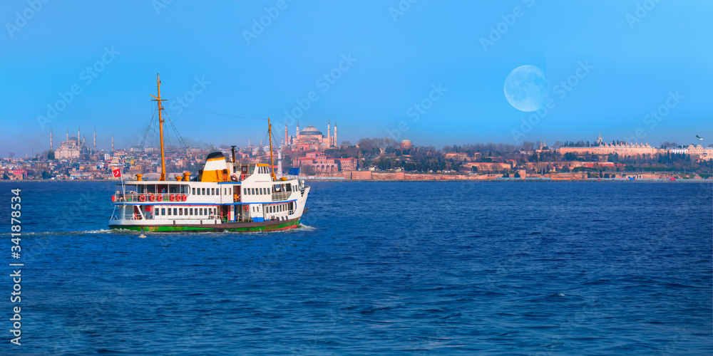 Water trail foaming behind a passenger ferry boat in Bosphorus on the background famous historical peninsula