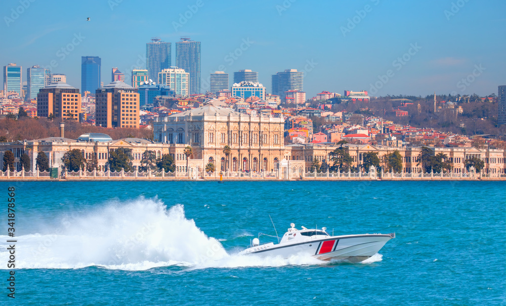 Obraz premium Coast Guard patrol boat rushing to the rescue on the background Dolmabahce Palace - Istanbul, Turkey