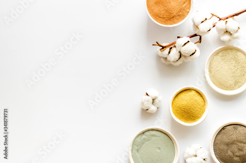 cosmetic clay - Yellow, red, white, blue and black - on white background top-down space for text