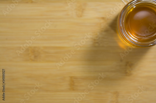 spoon is lowered into a jar of fragrant sweet honey and vypaskivaetsya from it. Honey drips from a spoon