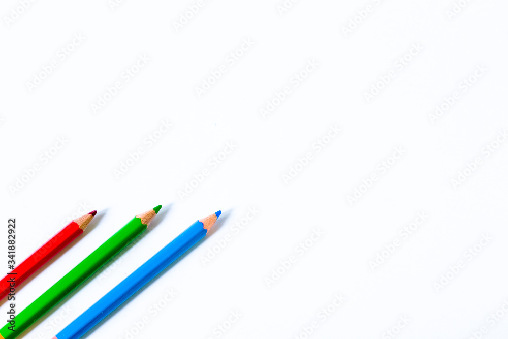 colored pencils over white background