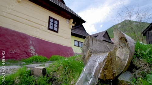 Old wooden houses and rural landscape in UNESCO village Vlkolinec in Slovakia photo