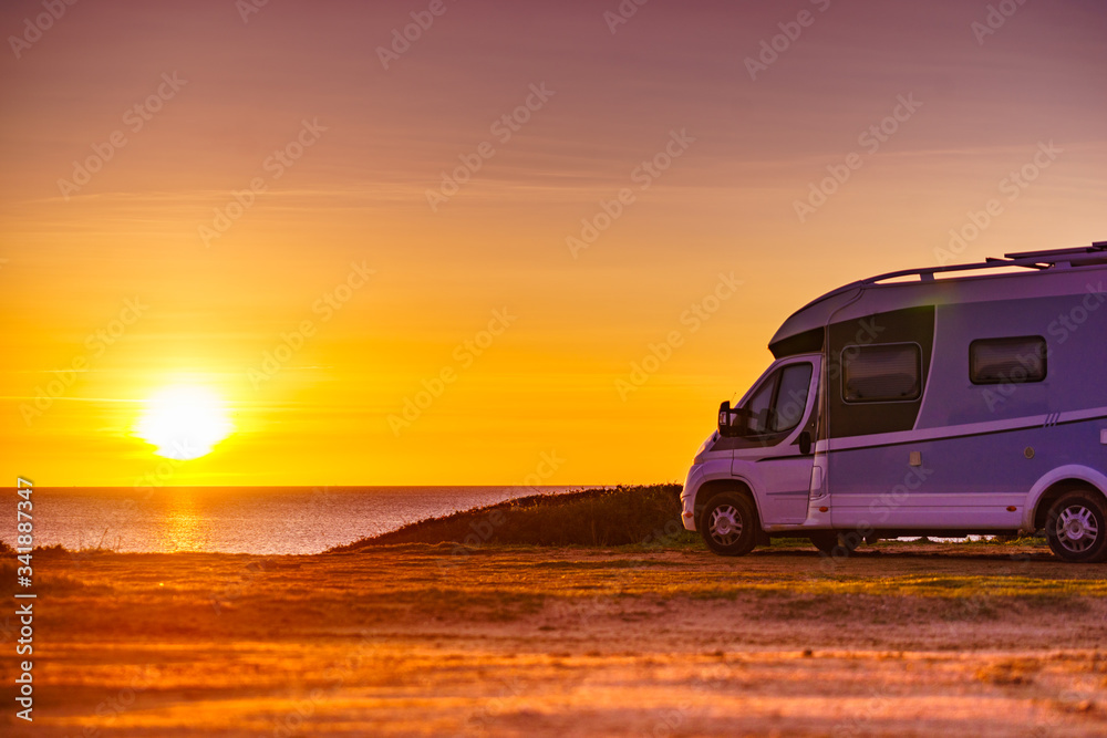 Fototapeta premium Camper car on beach at sunrise