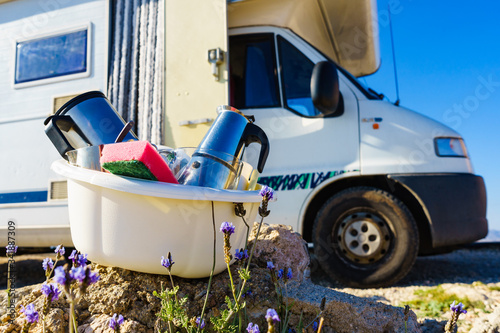 Washing dishes in bowl, capming outdoor photo