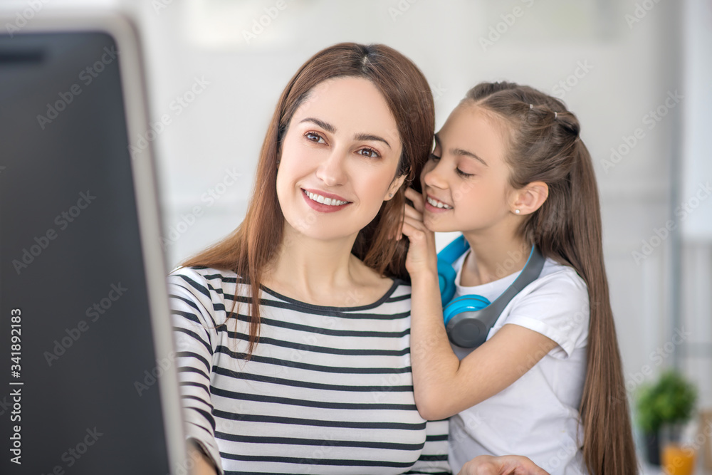 Sweet dark-haired girl sharing secrets with her mom Sweet dark-haired girl sharing secrets with her mom