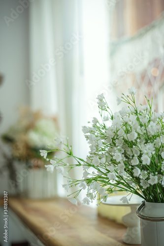 Bouquet of flowers in a decorative pot on the table empty cafe, Filled color filter.