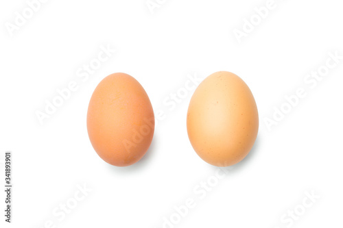 Two fresh brown chicken eggs on a white background