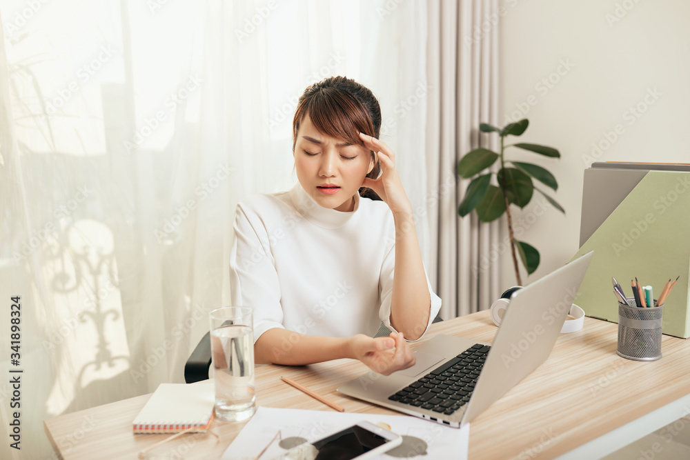 Asian woman feeling tired when working at her office, Asian woman feeling tired when working at her office,