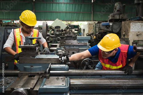 The industrial worker team is working on various projects in a large industrial factory with many equipment.