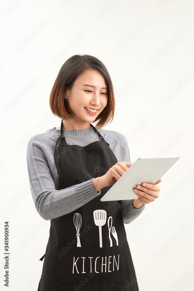 Successful hypermarket employee with black apron holding modern tablet isolated on white background with copyspace Successful hypermarket employee with black apron holding modern tablet isolated on white background with copyspace