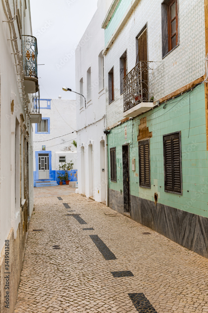 Narrow alley in the old town in Olhao, Algarve, Portugal.