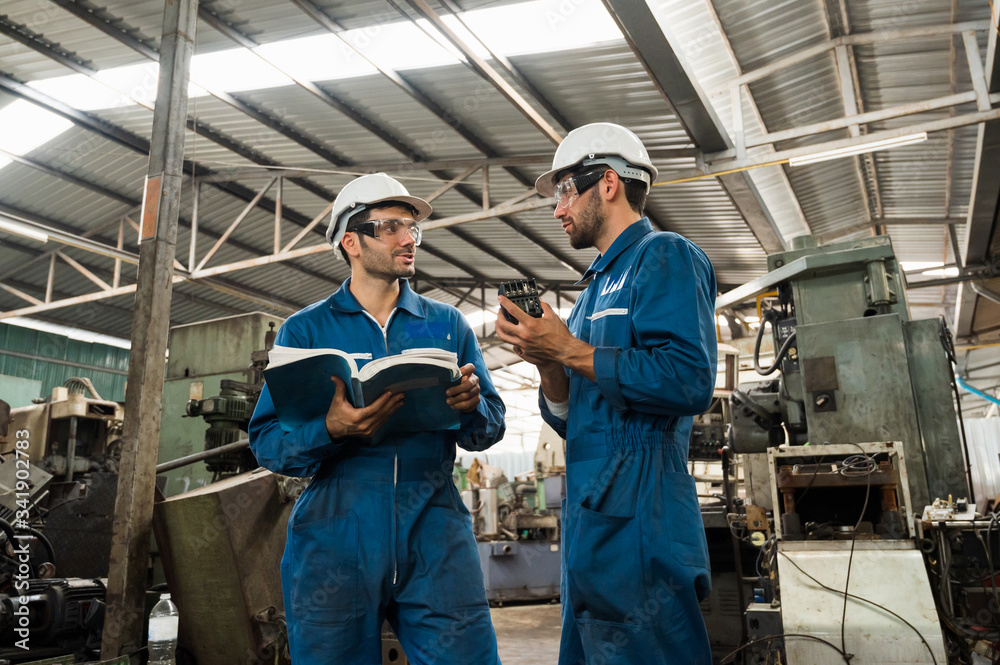 Industrial workers are working on projects in large industrial plants with many devices. Industrial workers are working on projects in large industrial plants with many devices.