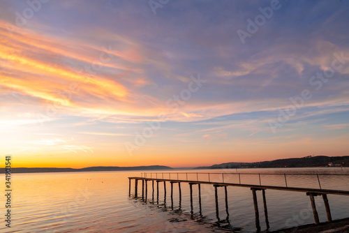 Pier and bridge on the sea, beautiful sunset, dramatic sky background