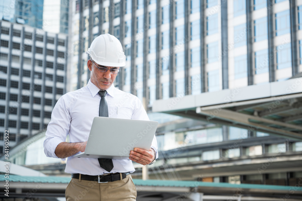 Civil engineering using laptop while working on building construction site. Civil engineering using laptop while working on building construction site.