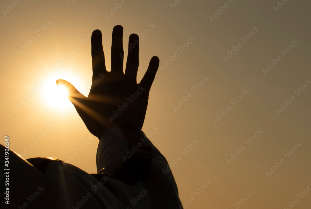silhouette of a man  and your hand in the sunset