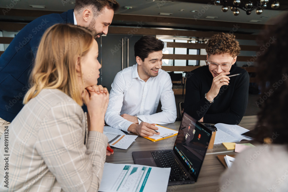 Group of smart motivated businesspeople working together Group of smart motivated businesspeople working together