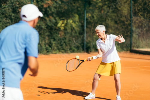 Mature Woman Playing Tennis © Microgen