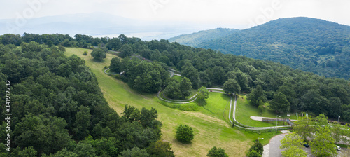 Obraz na plátně Summer bobsleigh in beautiful nature with green mountains and blue sky in Visegrad, Hungary, Europe, aerial stock photo