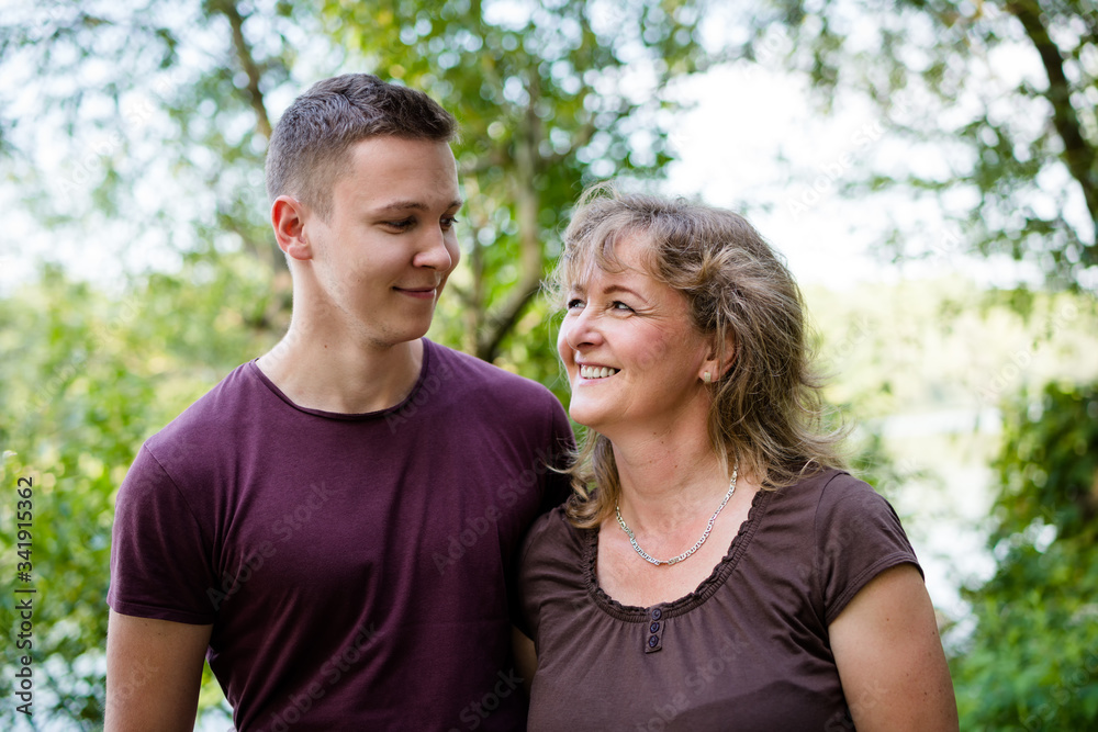 Cheerful mother with adult son outdoors. Family concept. Cheerful mother with adult son outdoors. Family concept.