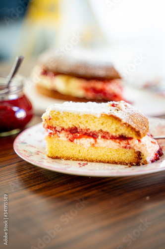 The Piece of Victoria Sponge Cake with Butter Cream and Strawberry Jam Filling