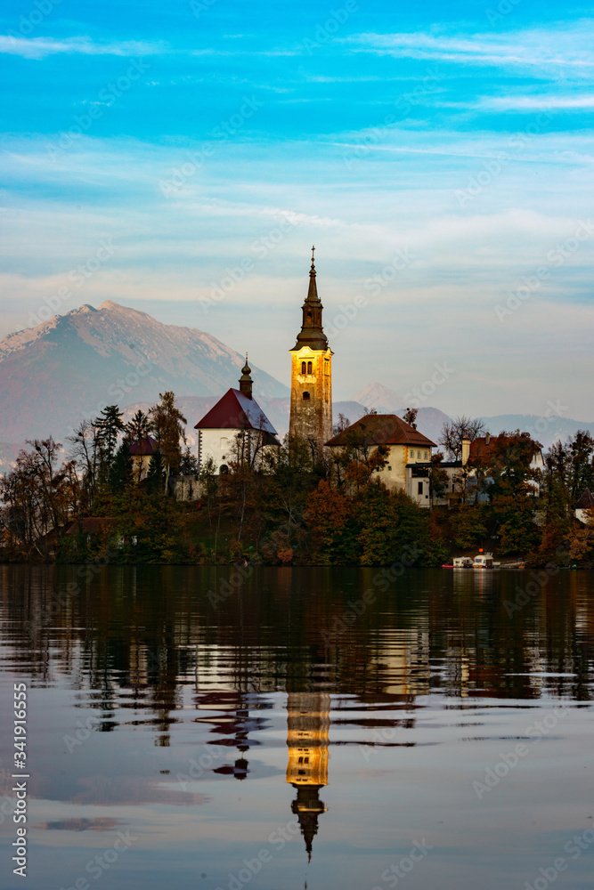 the church on bled lake at sunset