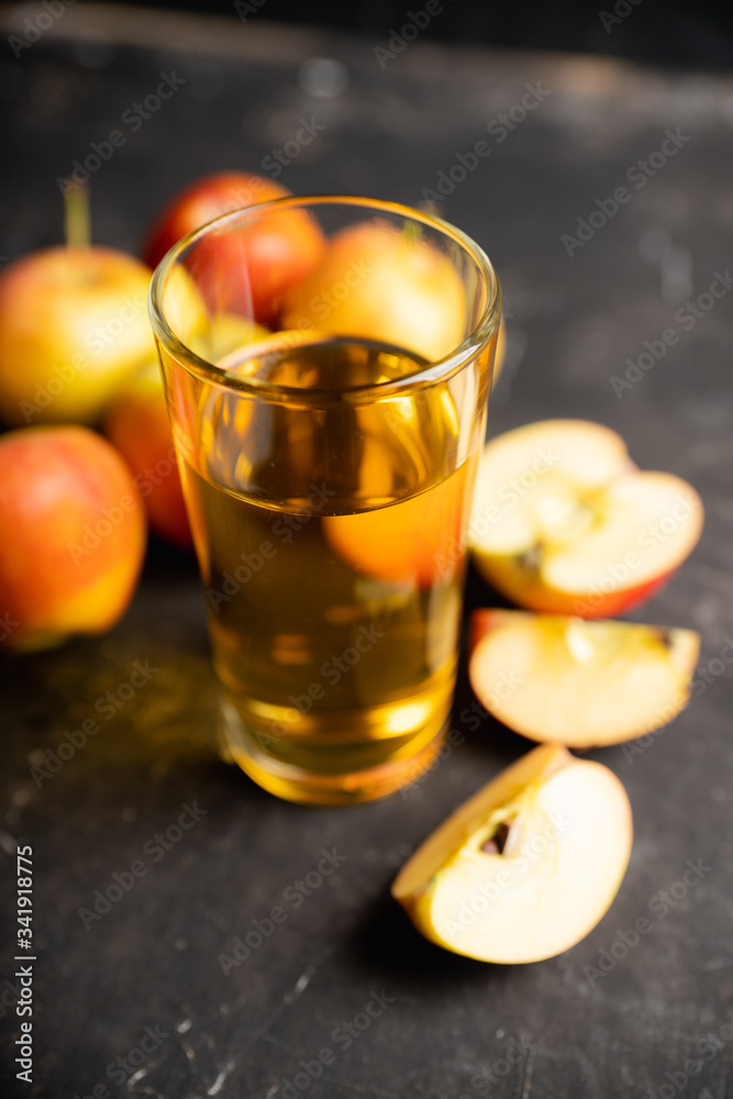 Apple juice with freshly harvested apples on the rustic background. Selective focus. Shallow depth of field. Apple juice with freshly harvested apples on the rustic background. Selective focus. Shallow depth of field.