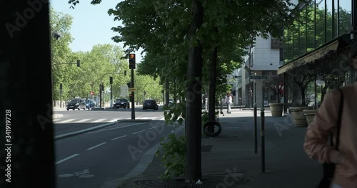 Woman crossing the street with trees