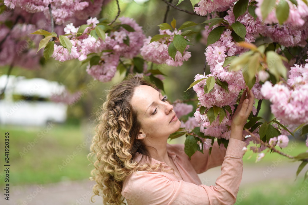 Fototapeta premium young woman walking in the city. young woman in pink dress