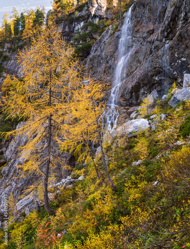 Autumn alpine waterfall view from mountain hiking path to Tappenkarsee, Kleinarl, Land Salzburg, Austria.