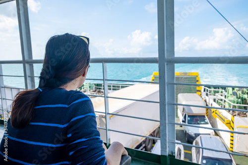 Close up portrait Happy thai woman enjoying the sea from ferry. summer, holidays, vacation, travel and active lifestyle concept © Haluk