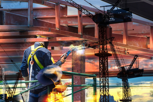 Double exposure of electric welder works on scaffolding, Safety,Construction wearing safety harness and Safety line working on a Metal indutry structure installed scaffolding. photo