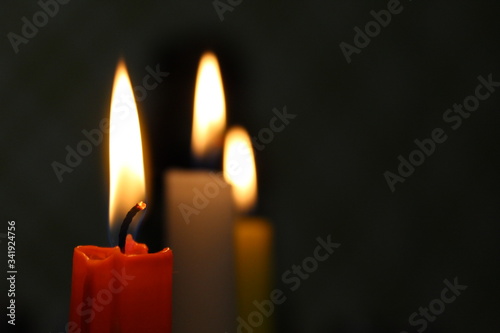 Red candle on dark background