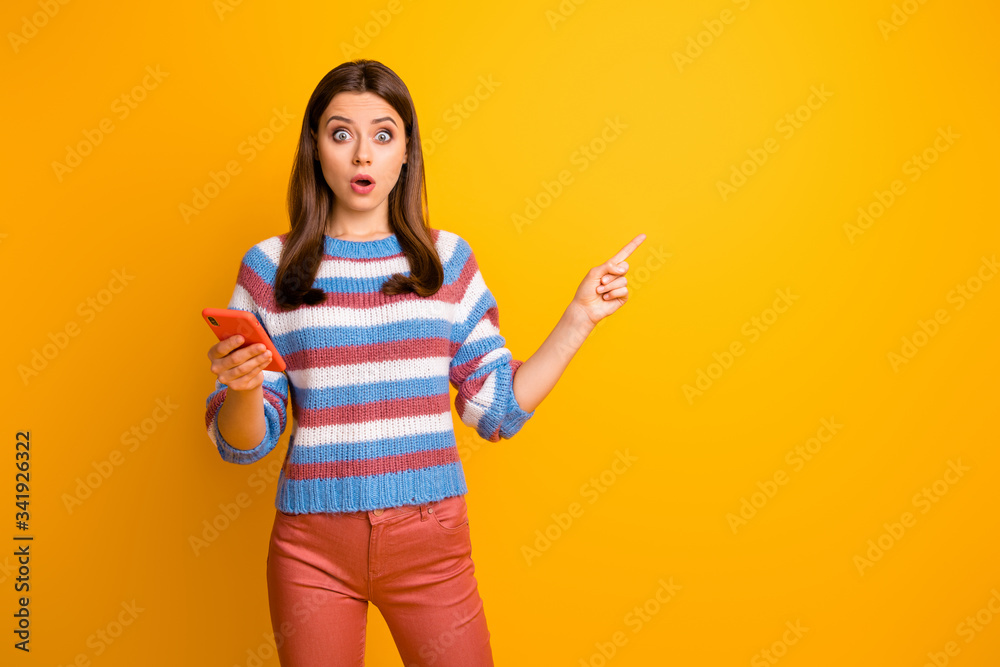 Portrait of her she nice attractive lovely amazed wondered astonished brown-haired girl holding in hands cell showing copy space isolated on bright vivid shine vibrant yellow color background Portrait of her she nice attractive lovely amazed wondered astonished brown-haired girl holding in hands cell showing copy space isolated on bright vivid shine vibrant yellow color background