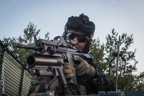 a man aiming in the scope of his weapon during the preparation in the Canjuers camp of French soldiers leaving for four months of Opex in Mali  photo