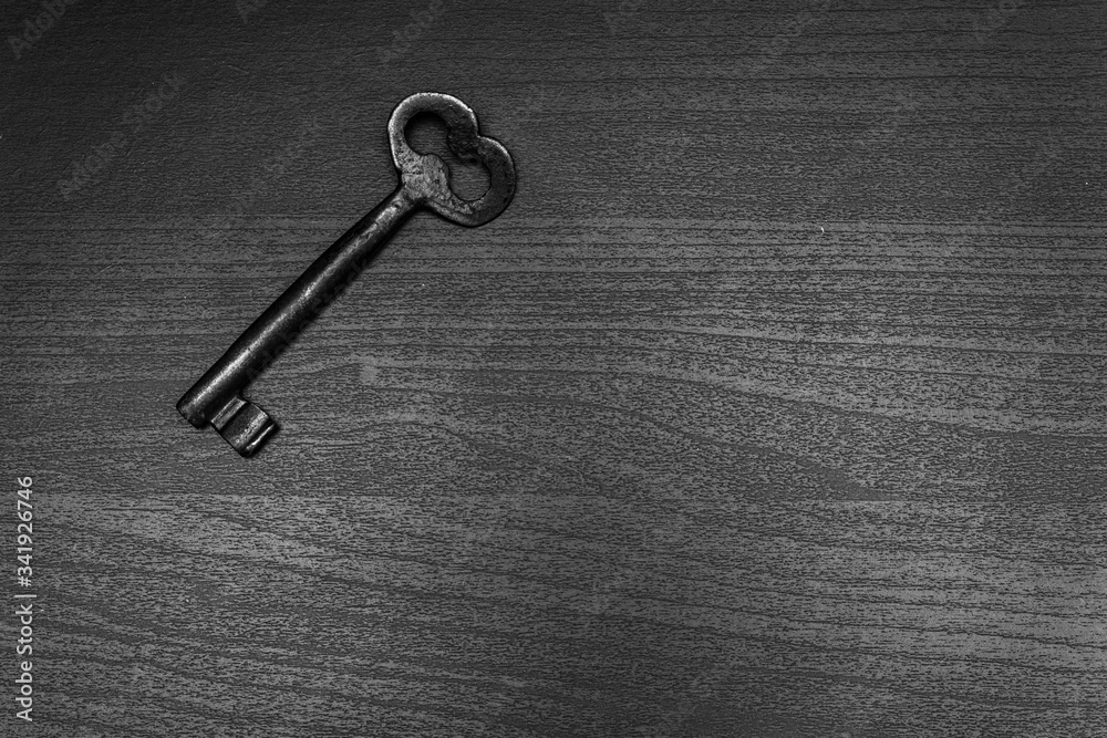 old key on dark wooden table old key on dark wooden table